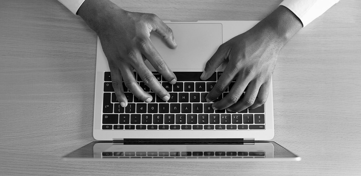 Image of hands on a desktop keyboard