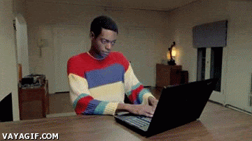 Gif of a man typing on a laptop, with a second man emerging from inside of 1st man's sweater