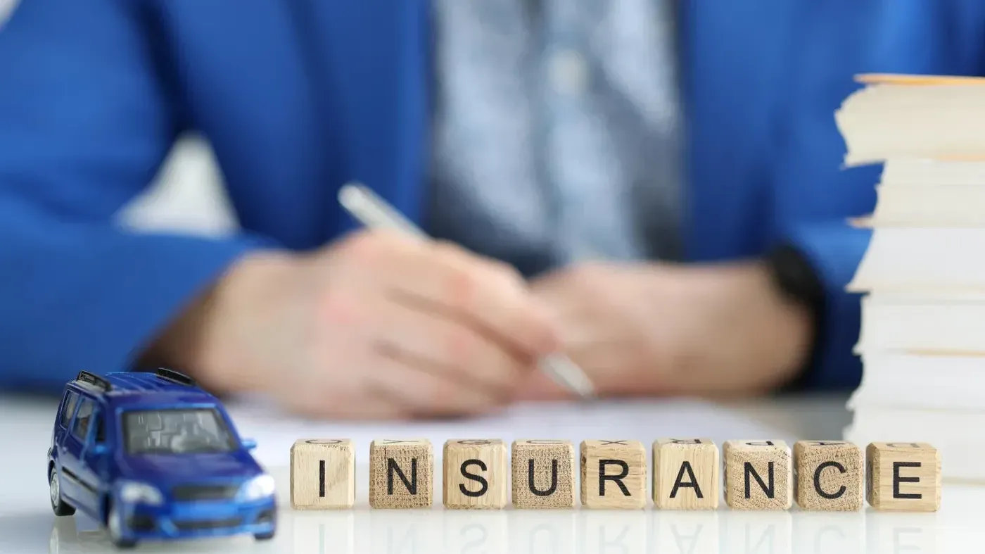 insurance building blocks with broker in background
