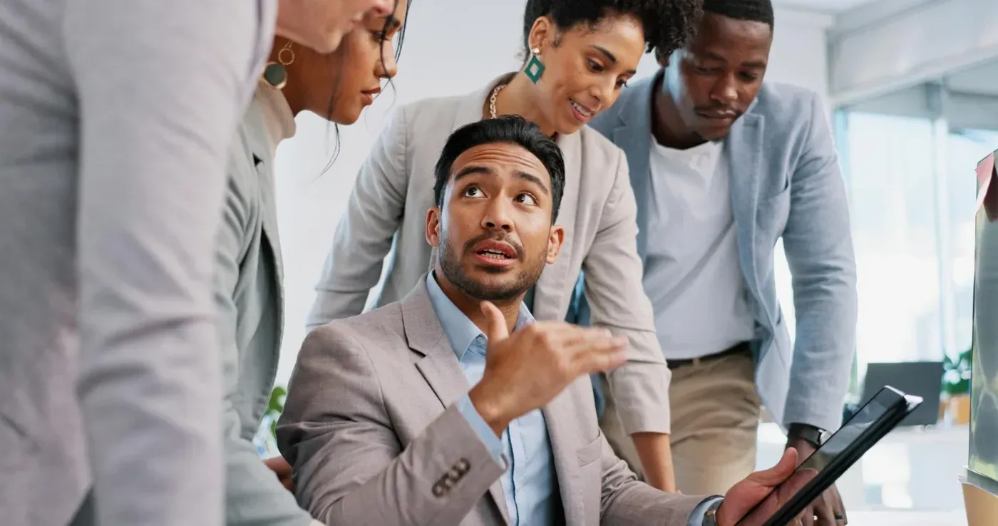 A team of insurance professionals discuss quotes in an upscale office